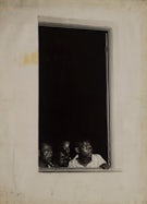 Black and white photograph of people looking out of a window